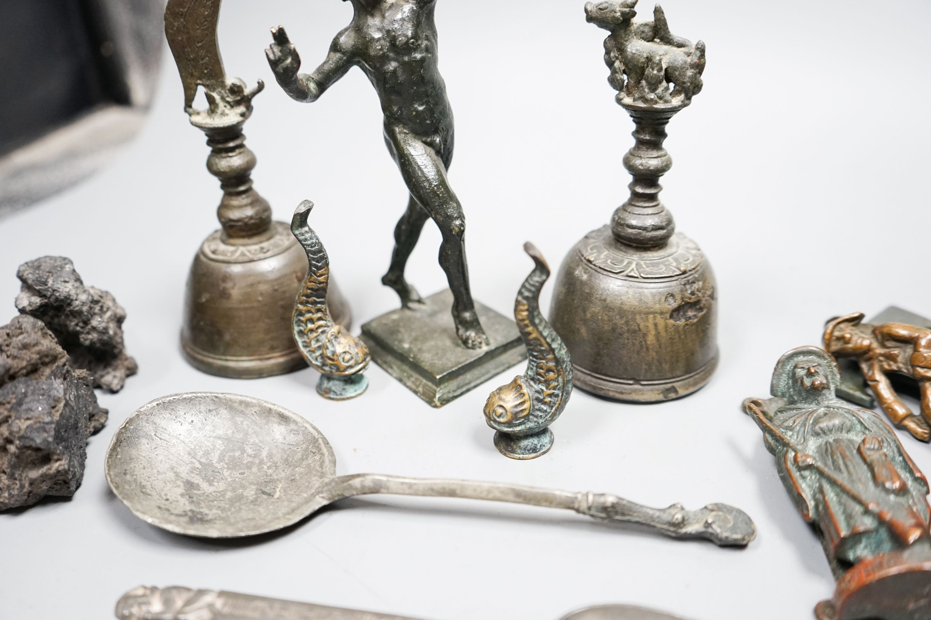 A small quantity of decorative metalware, including two bronze table bells, a bronze faun, 17cm, pewter spoons, etc.